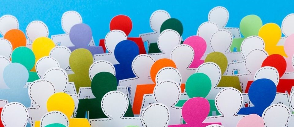 paper cut outs of people in large group