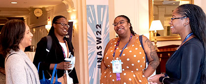 four black women chat at NASW's 2022 national conference