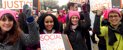 people at a rally, holding signs that say social workers for social justice