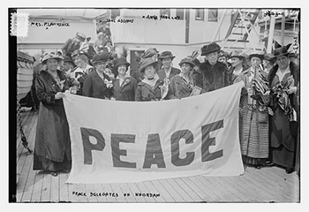 archival photo of women holding a banner that reads Peace