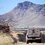 border patrol truck drives on a dirt road