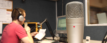 microphone and desktop screens in a radio studio