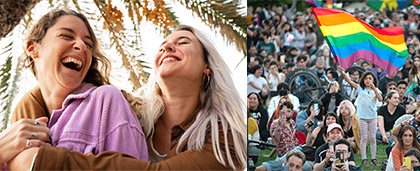 two women, smiling and a pride flag