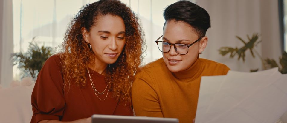 two people working together at dining room table