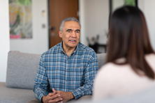 man speaking with therapist