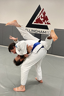 Tolman, standing, practices a hip-throw with Bellingham BJJ Manager Jesse Johns on Aug. 17