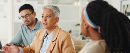 women speaking at table