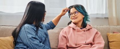 2 people sitting on couch talking