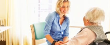 Woman speaking with other woman in wheelchair