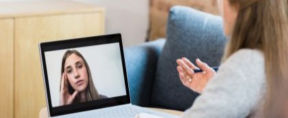 woman video chatting with another woman on a laptop