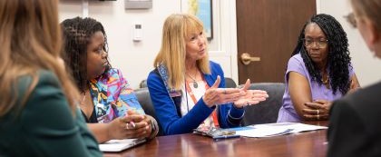 people discussing something around a board table