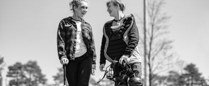 two persons wearing sports gear and conversing