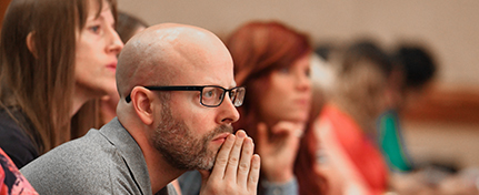 seated conference attendees listening intently