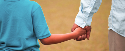 child holding hands with an adult