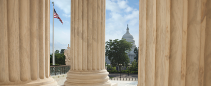 view of the U.S. Capitol building through pillars