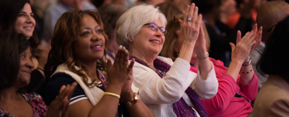 people clapping at a conference