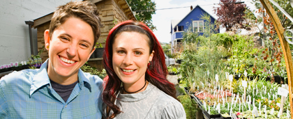 smiling lesbian couple standing in the garden