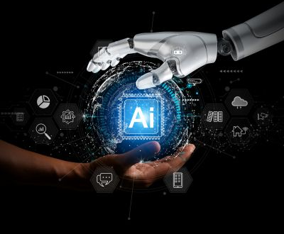 Robot hands surrounding text saying AI