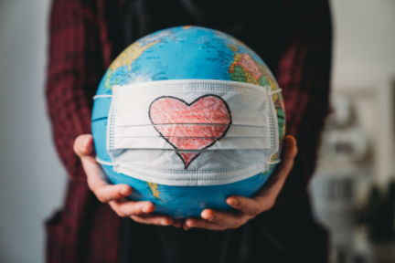 globe with face mask with heart drawn on it