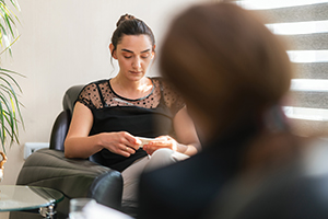 anxious woman playing with tissue