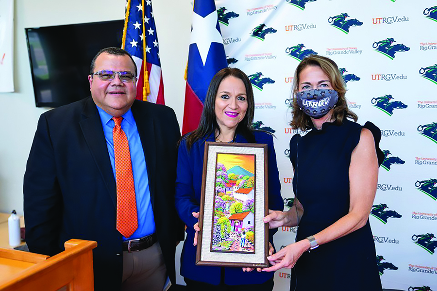 At the signing of a memorandum of understanding between the University of Texas Rio Grande Valley (UTRGV) and the Salvadoran Lutheran University (SLU) in September, Ada Ruth Gonzalez (center), SLU director of international relations, presents a commemorative gift to Dr. Luis Torres-Hostos, founding dean of the UTRGV School of Social Work, and Dr. Janna Arney, UTRGV deputy president and interim provost.
