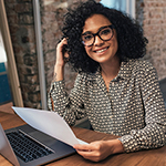 smiling woman sitting at desk