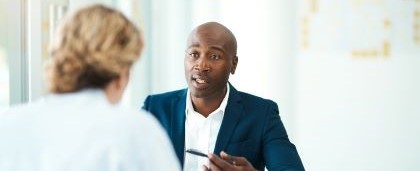 man explaining something across a desk