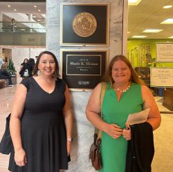 2 Participants of NASW advocacy pose together in front of Mazie Hirono's office