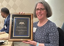 Dina Kastner holding award from ABA