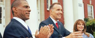 three people at podium outdoors