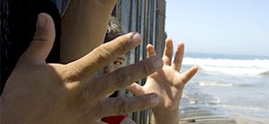 child hand, adult hand, fence, ocean