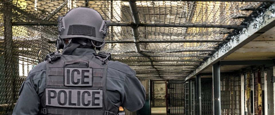 ICE officer walking through facility