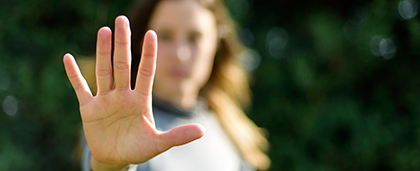 woman holding her palm out to camera