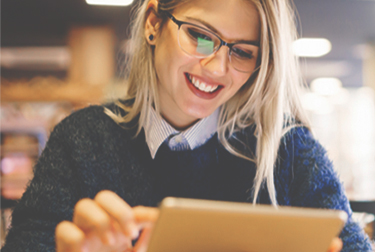 young woman reads on a tablet