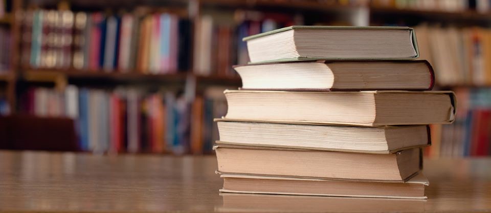 pile of books on a library table