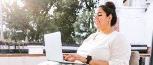 woman smiling at computer