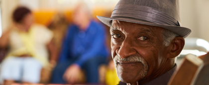 smiling man with grey mustache and hat