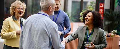 smiling woman shakes hand of colleague