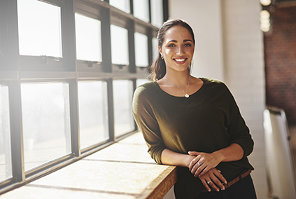 smiling woman in sunlit window