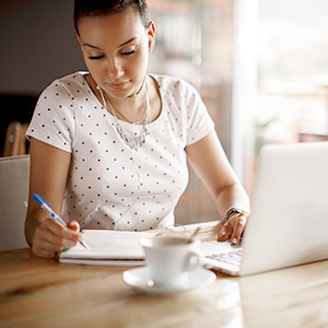 woman with laptop and notebook