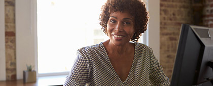 smiling professional woman sitting at desk