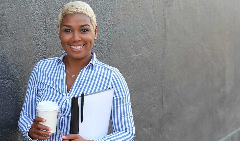 young woman with coffee cup and notebook