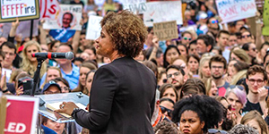 woman speaks at rally