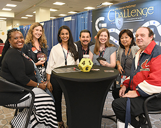 group of people around a table in exhibits area