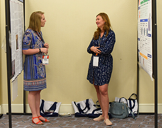 two women speaking in poster sessions area