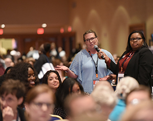 attendee asks speaks into microphone