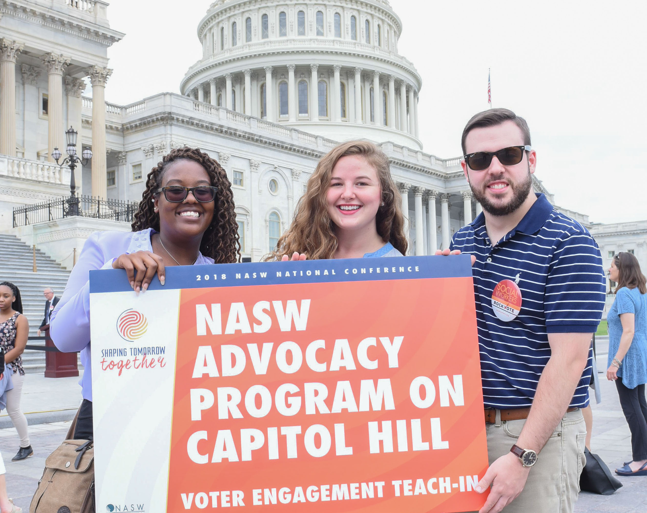 three people hold sign that says NASW advocacy program on Capitol Hill