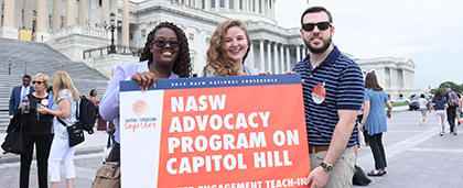 three people hold sign that says NASW Advocacy Program on Capitol Hill