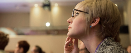 conference attendee listening to speaker