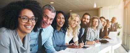 group of smiling co-workers in a line